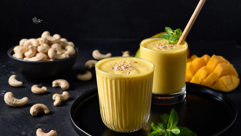 Vegan cashew milk mango lassi served with fresh mango and cashews